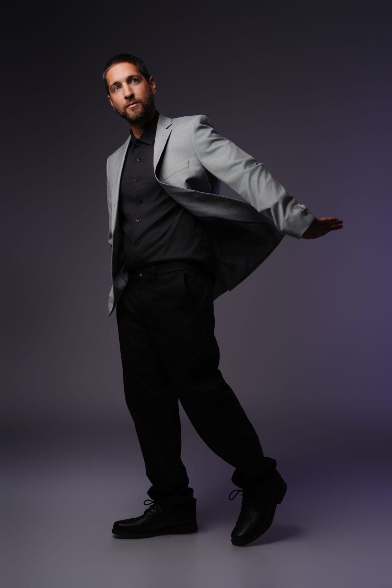 Justin Samuel Parsons posing with jacket in motion